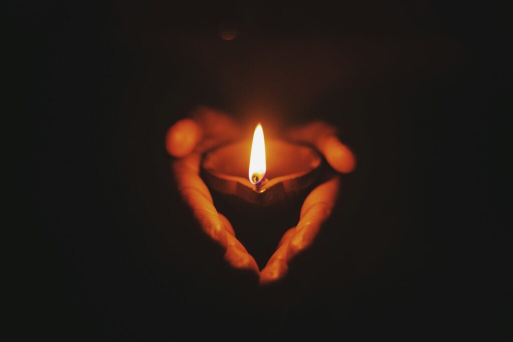 Hand holding a candle