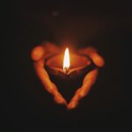 Hand holding a candle