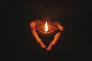 Hand holding a candle